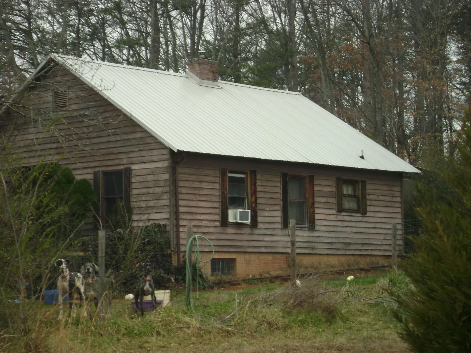 White metal roof on an old wood sided farmhouse, from a Metal Roof Installation job in Iselin